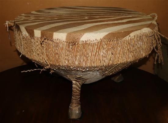 A zebra skin drum/coffee table(-)